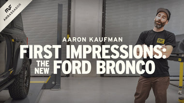 magnaflow ambassador aaron kaufman standing next to 2021 ford bronco with arms crossed wearing a black magnaflow logo t-shirt
